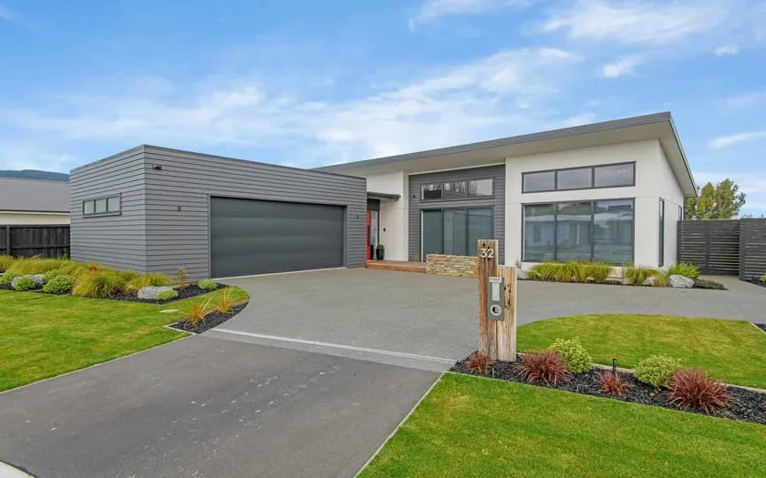 A Pringle Homes build at Adrossan, grey weatherboard and white gable, from the street